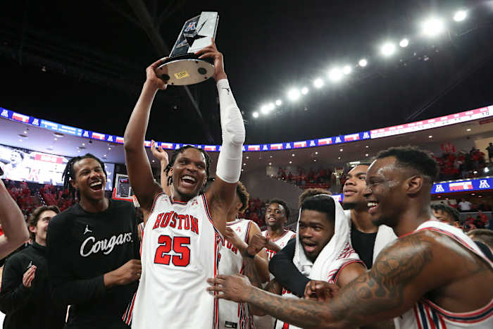 Houston Cougars center Josh Carlton (25) and guard Taze Moore (4) and teammates celebrate winning the American Athletic Conference after defeating the Temple Owls at Fertitta Center.